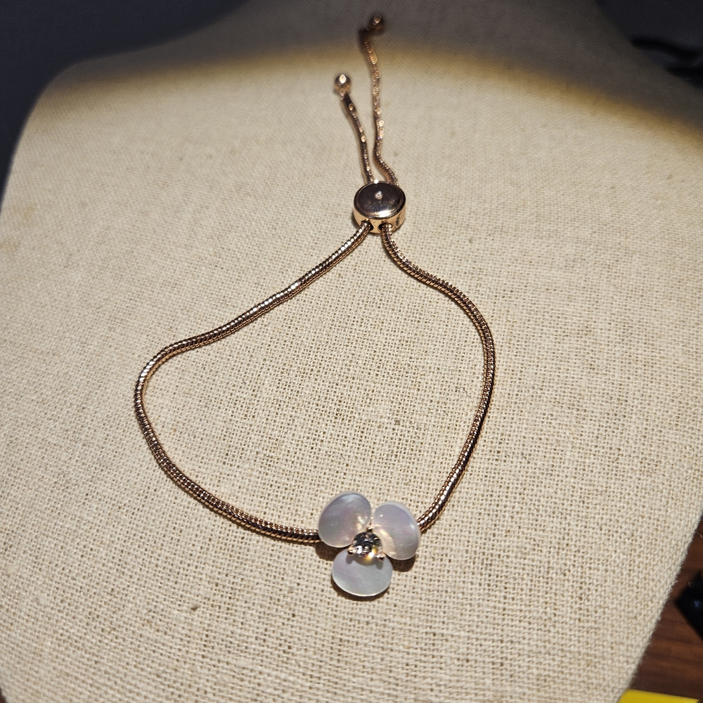 Kate Spade Rose Gold-tone disco pansy slider bracelet.